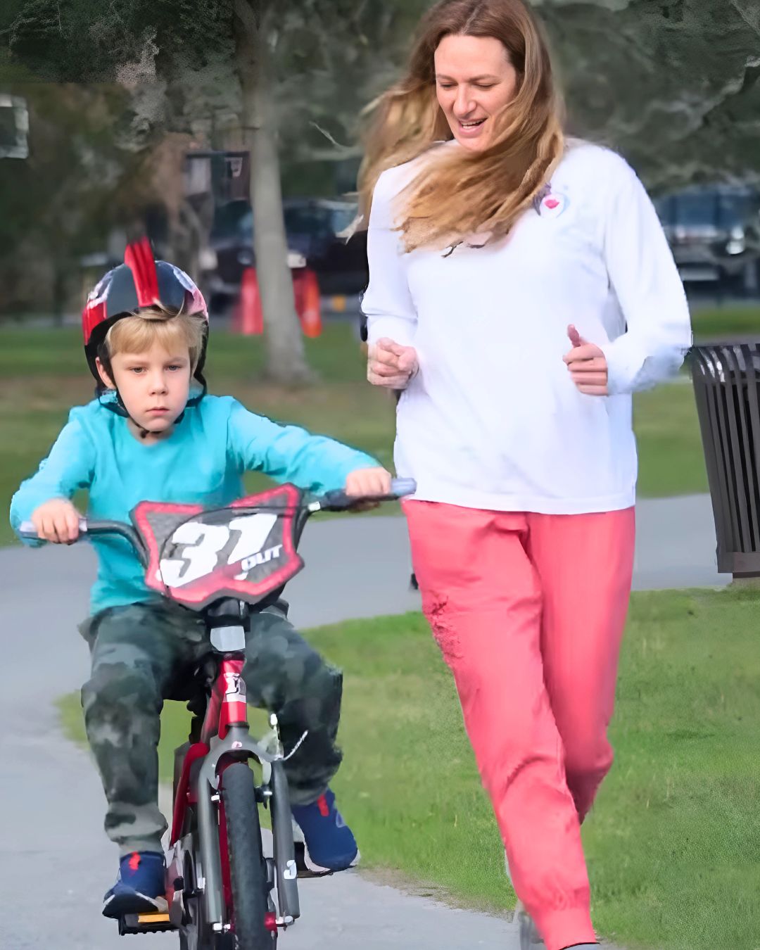 Child learning to ride a bike with pediatric therapist in Metairie